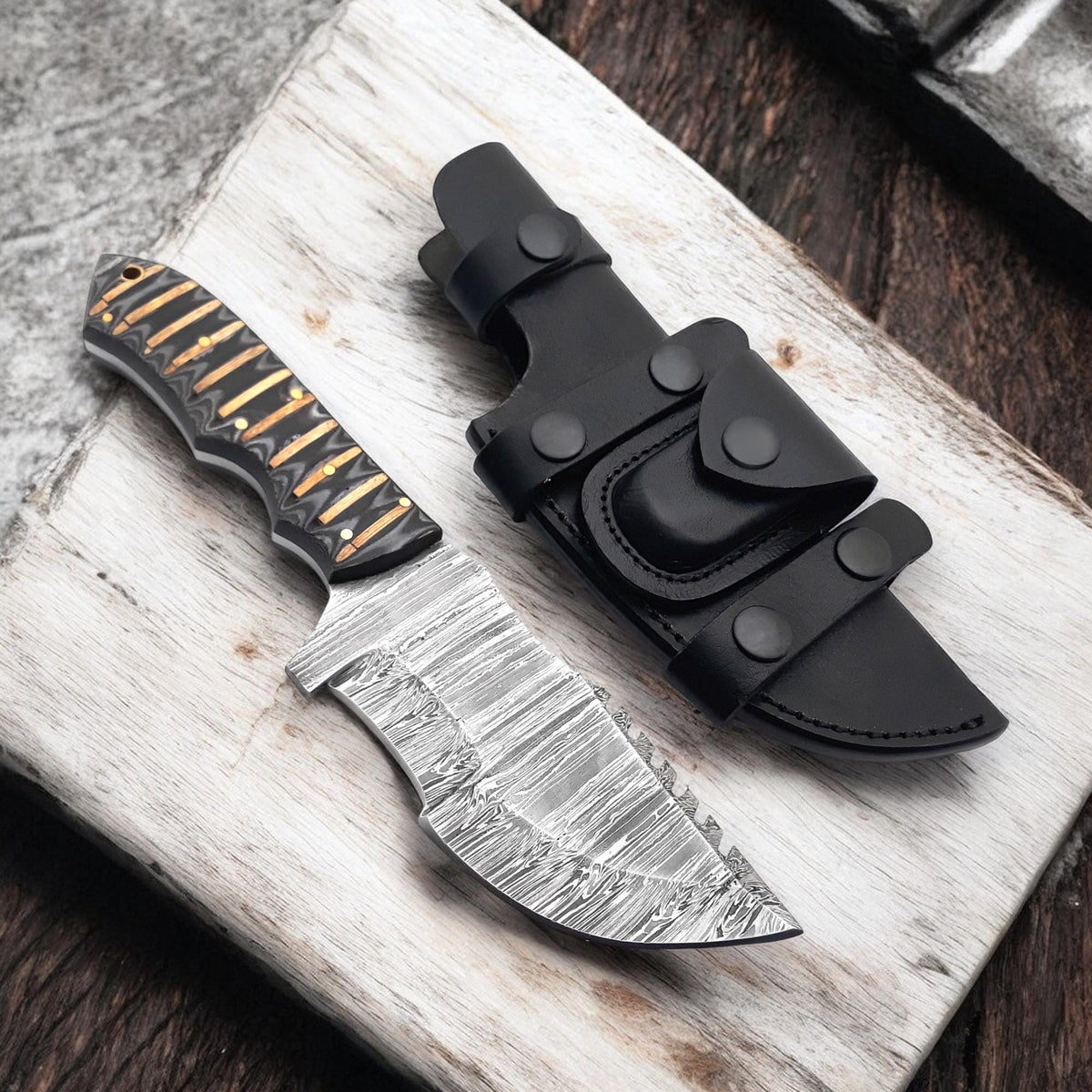 Damascus steel tracker knife with G10 handle and leather sheath

