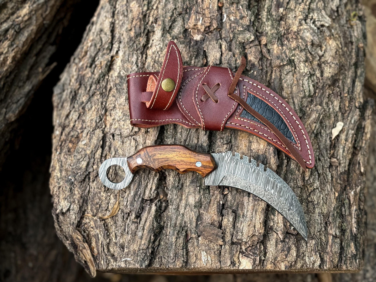 Full-tang Damascus karambit knife displayed with leather sheath


